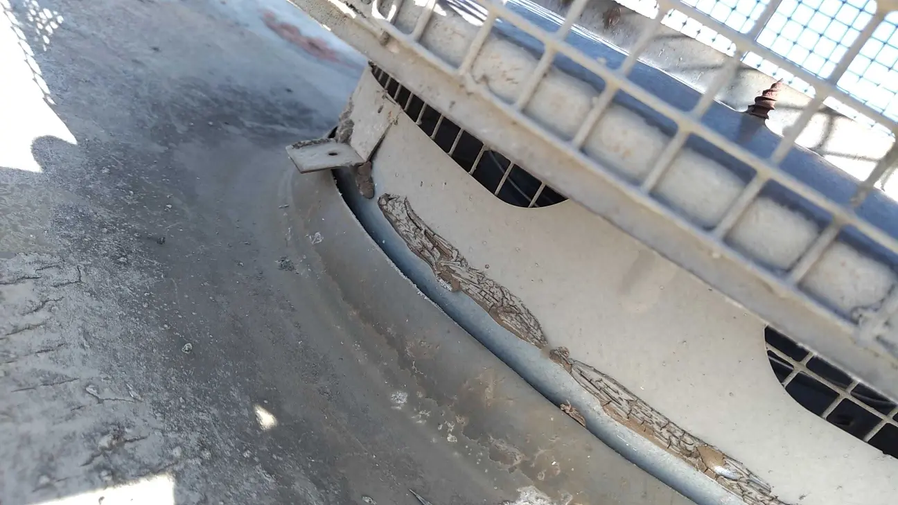 Close-up photo of chimney cap damage where wind-driven rain entered the Beaumont home