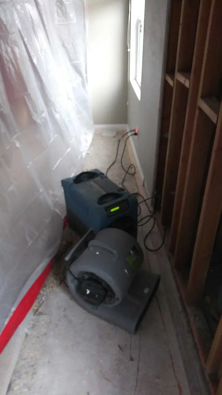 Containment and air mover set during Beaumont water damage dry-out