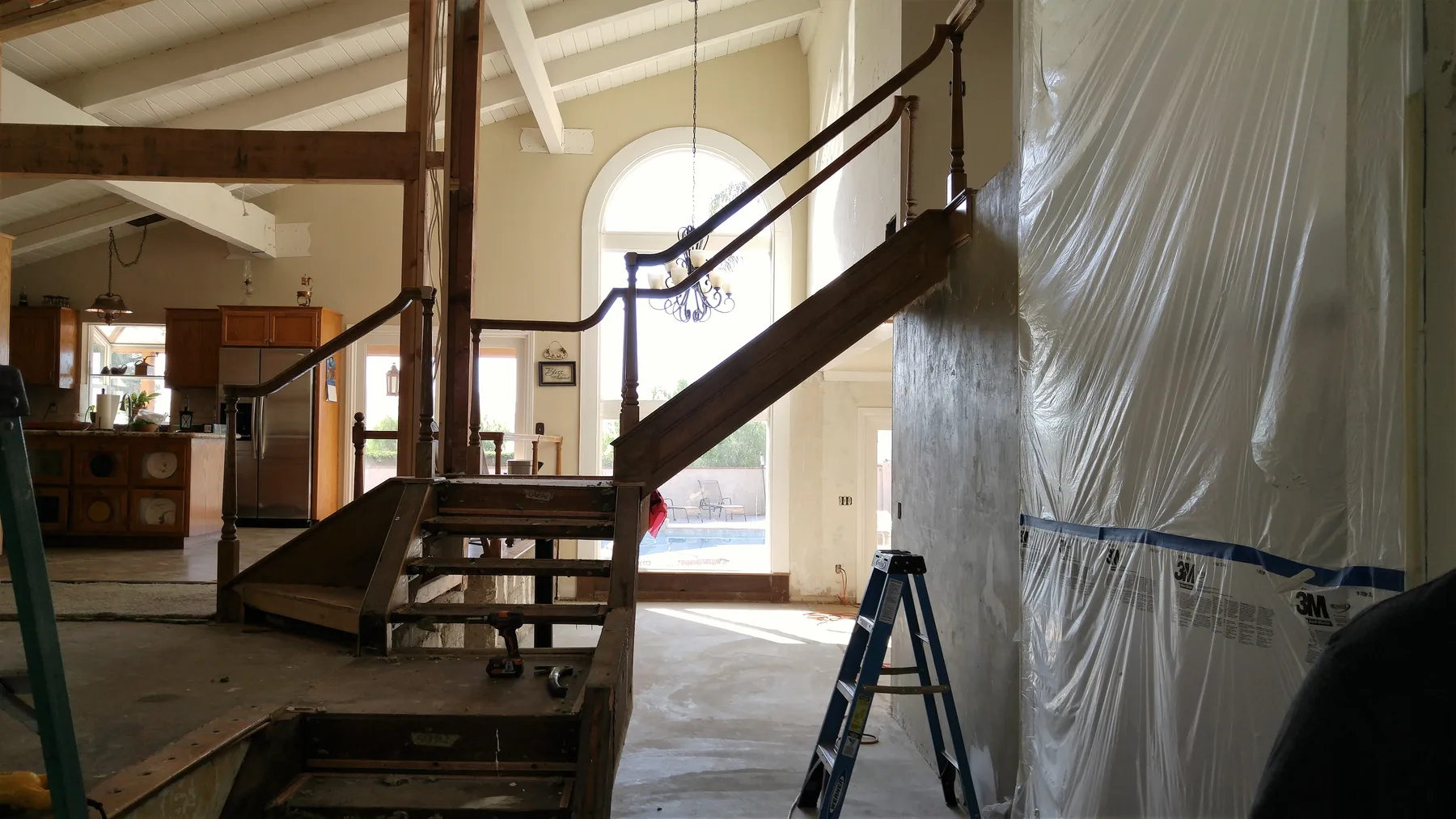 Corona custom stair rebuild project by PL Builders showing demo protection and stair area before rebuild