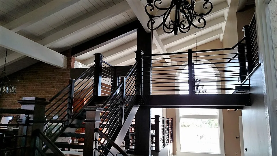 Finished custom staircase: Corona custom stair rebuild project by PL Builders with wood posts and metal railing
