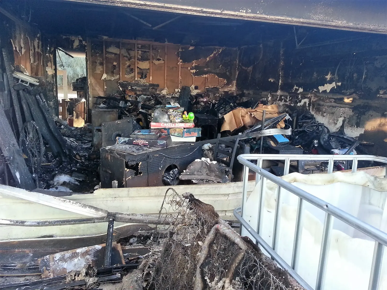 Burned garage opening before board-up: Twentynine Palms fire damage restoration project by PL Builders showing Emergency Board-Up After Garage Fire - Twentynine Palms, CA