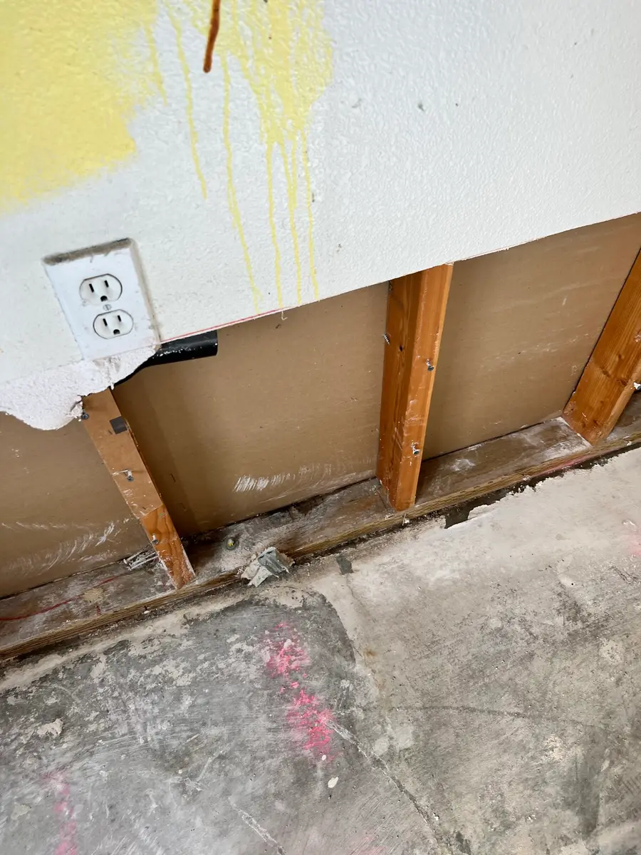 Opened wall cavity from upstairs burst pipe water damage during San Jacinto water damage restoration project by PL Builders