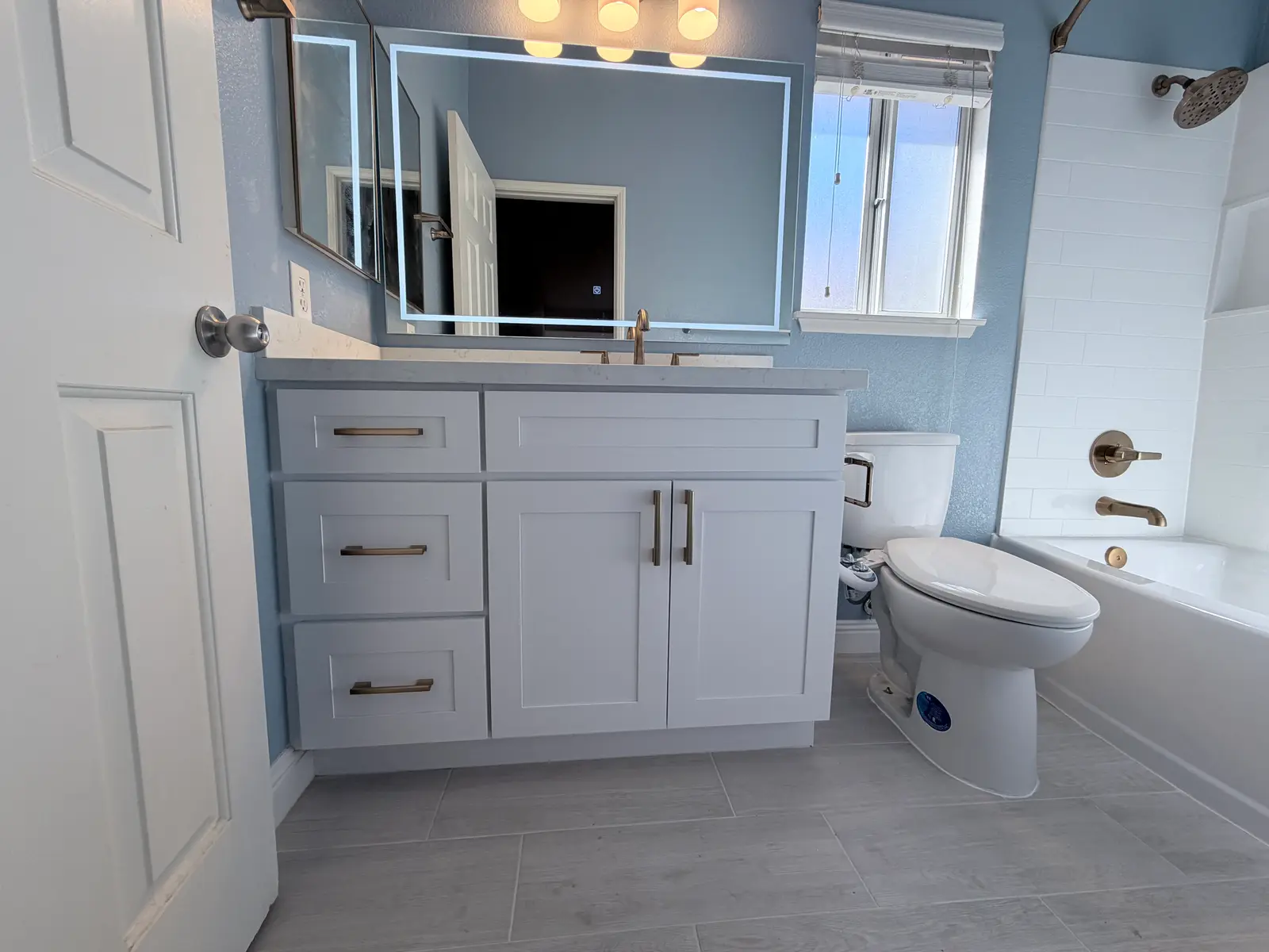 Temecula broken toilet drain water damage restoration with bathroom mitigation, ceiling and wall repair, and finished bathroom reconstruction