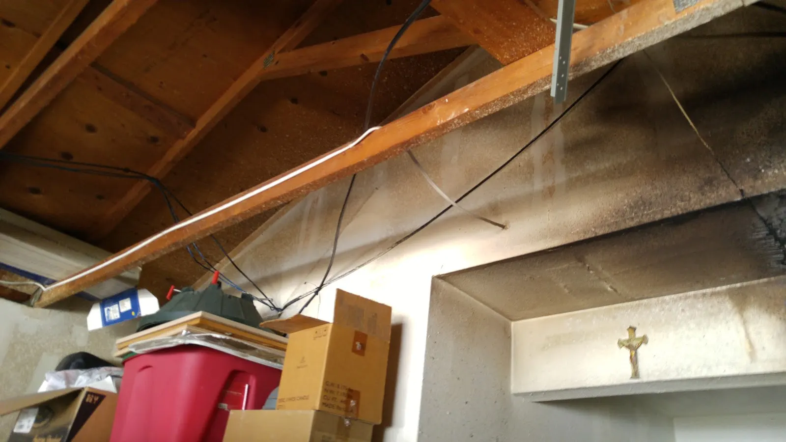 Moreno Valley garage fire restoration photo showing burned drywall, smoke staining, and exposed framing documentation